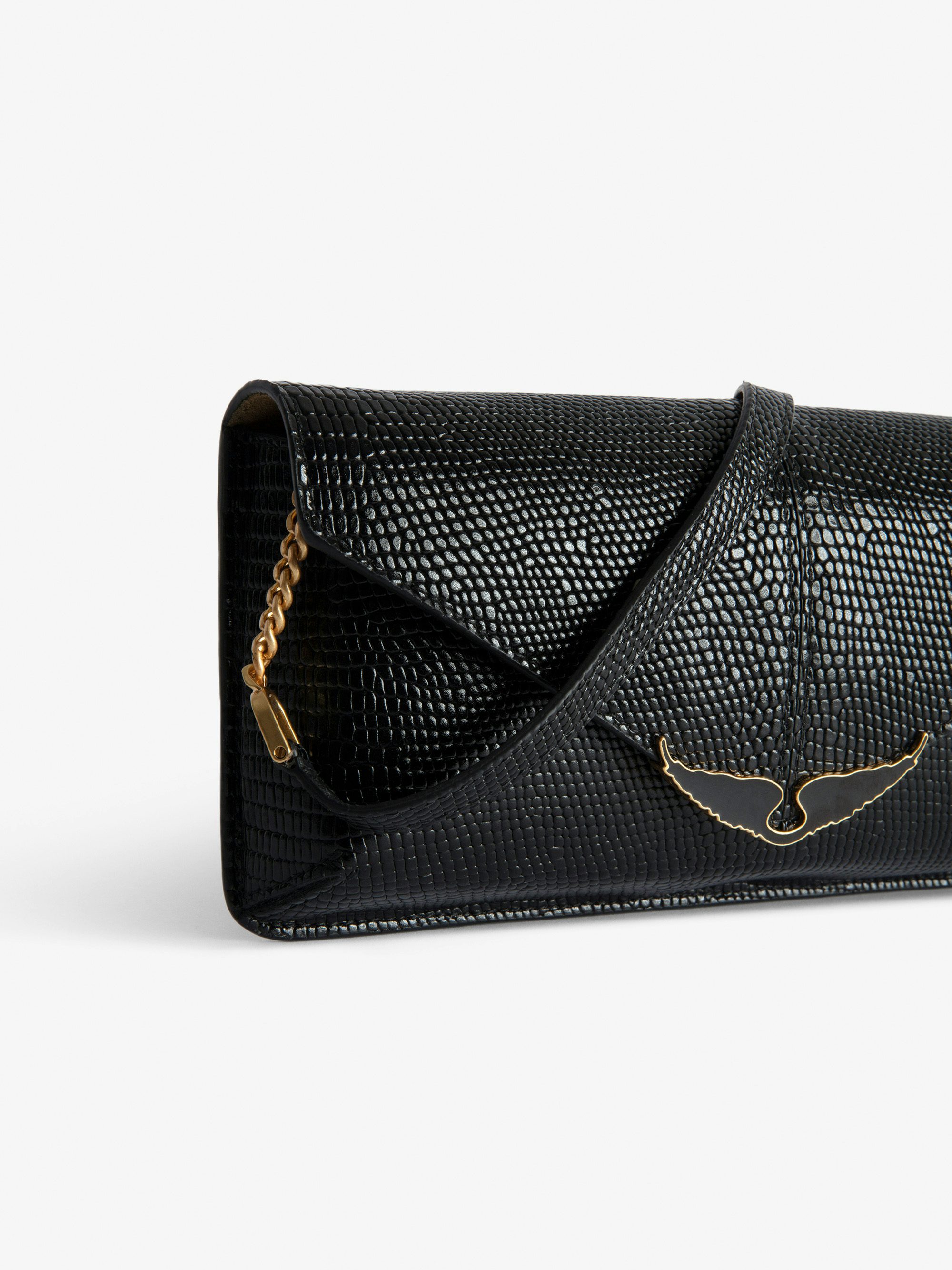 Borderline Embossed Clutch - Women’s black iguana-embossed leather clutch with shoulder strap with wings charm.